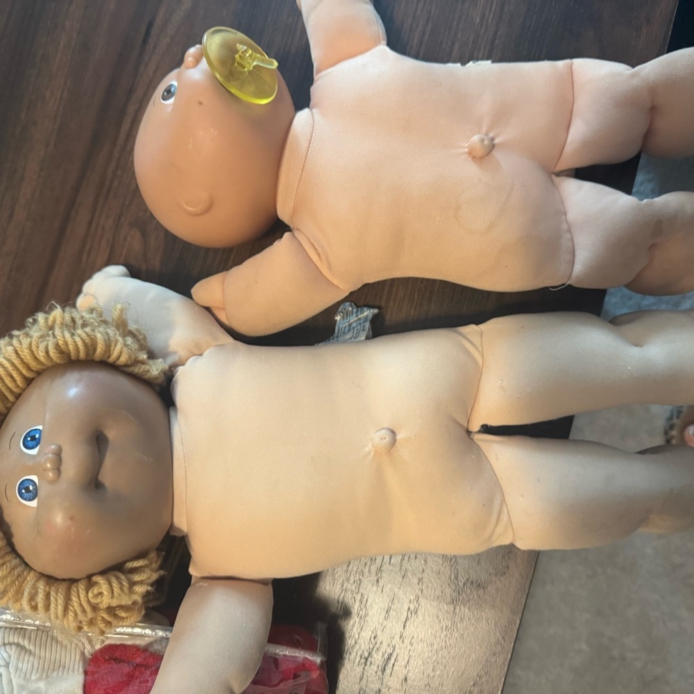 Two cabbage patch dolls with outfits and shoes